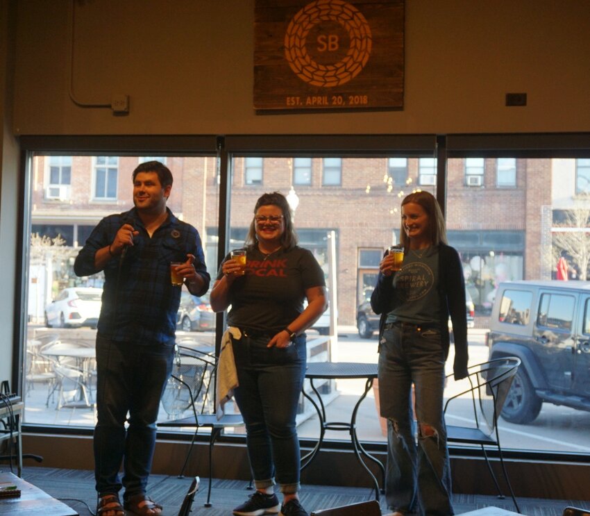Spiral Brewery owners (from left) Nick Fox, Jen Fox, and Amy Fox toast to the seven-year anniversary of Spiral Brewery.