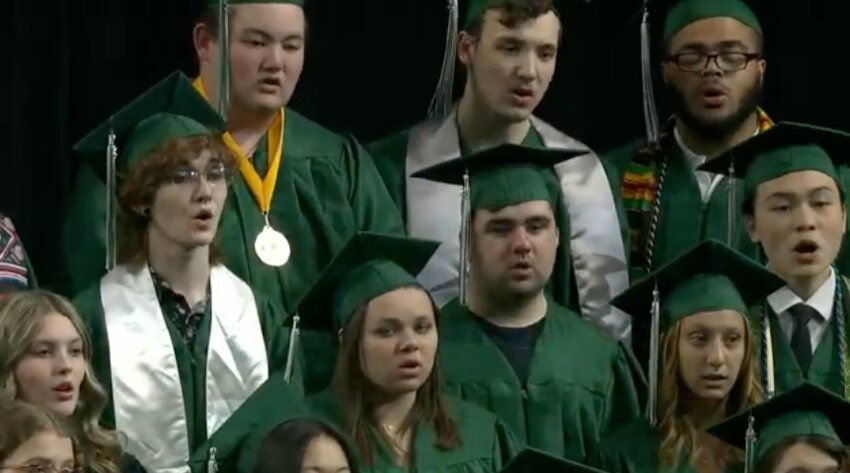 Members of the Park High Concert Choir sing “And So It Goes” Under the direction of Choir Director Benjamin O’Connor at the 2025 Park High School Commencement at 3M Mariucci Arena in Minneapolis June 10.