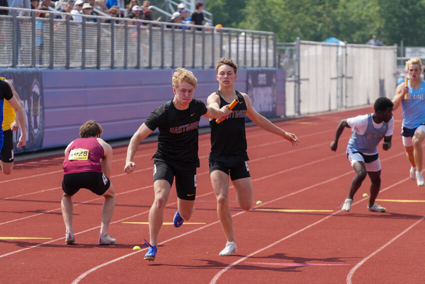 The 4x200 team of Cole Zeien, Gunner Hanstad, Sebatian Strauss and Lane Hoffman just missed the MSHSL state record of 1:25.58 with their 1:25.80 first place finish for 2025. (left) Zeien led the relay, handing it to Hanstad who then passed the baton to Strauss. Strauss made the last baton pass to Hoffman (right) who finished the race strong for the top of the podium.