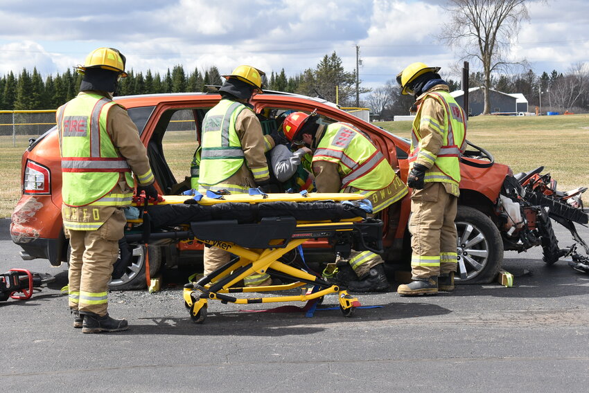 5 Final preparations before Serocki is extricated from the vehicle. 