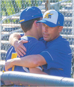 Head Coach Ryan Stoffel gives his senior son, Connor, an emotional hug after the Raiders season ended at Rosemount in the Section 3AAAA tournament. After the dust settled and the team started cleaning up, Stoffel said &ldquo;I will definitely be back,&rdquo; regarding his plans for coaching next year. Photo by Bruce Karnick
