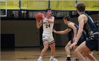 River Falls senior guard Joey Butz looks for an open teammate during the Wildcats&rsquo; game against Hudson earlier this season. Butz had a season-high 26 points in the loss on the road against Eau Claire Memorial on Friday, Dec. 16. Photo by Reagan Hoverman