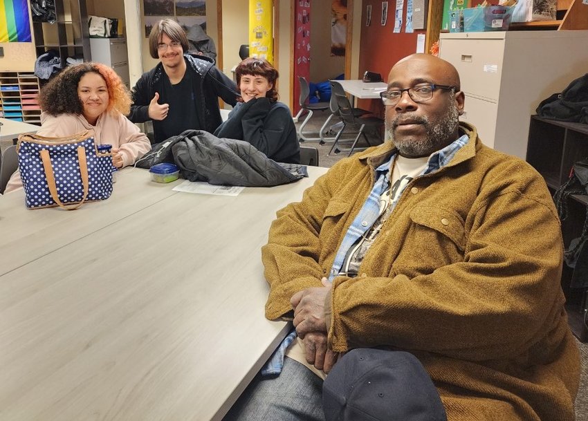 (From left) River Falls Renaissance Academy students Ciara Roberson, Halvard Herfindahl, and Savannah Stern chat with St. Croix Valley Restorative Services facilitator Kelvin Pooler, who recently received a Wildcat Pride award for his work at the Ren.