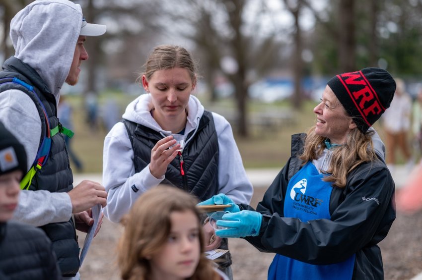 Grace Coggio, right, UW-River Falls sustainability fellow and communication studies associate professor, speaks with attendees about water quality during last year&rsquo;s inaugural Earth Fest in River Falls. This year&rsquo;s event is set for April 22.