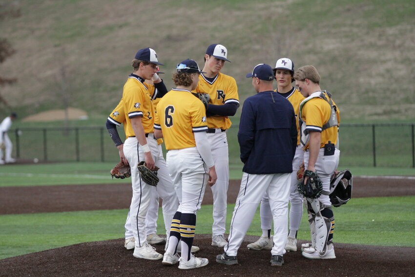 River Falls head coach Ryan Bishop meets with his players on the mound during the late innings of the Wildcats&rsquo; home game against Hudson on Thursday, April 27.