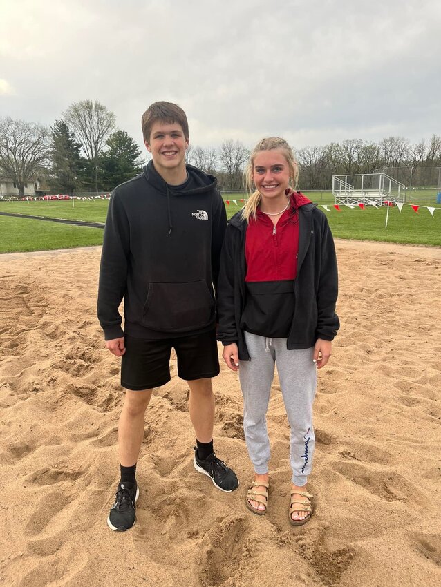 Elmwood/Plum City seniors Trevor Asher and Izzy Forster celebrate together after breaking their own school records in the triple and long jump events respectively at the Colfax meet on Tuesday, May 9.