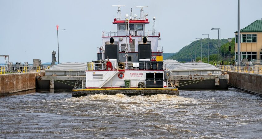 The tug Theresa L. Wood heads upstream after locking through Lock and Dam #8 May 17 in Genoa, Wis. The vessel was moving barges from St. Louis to Winona, Minn.