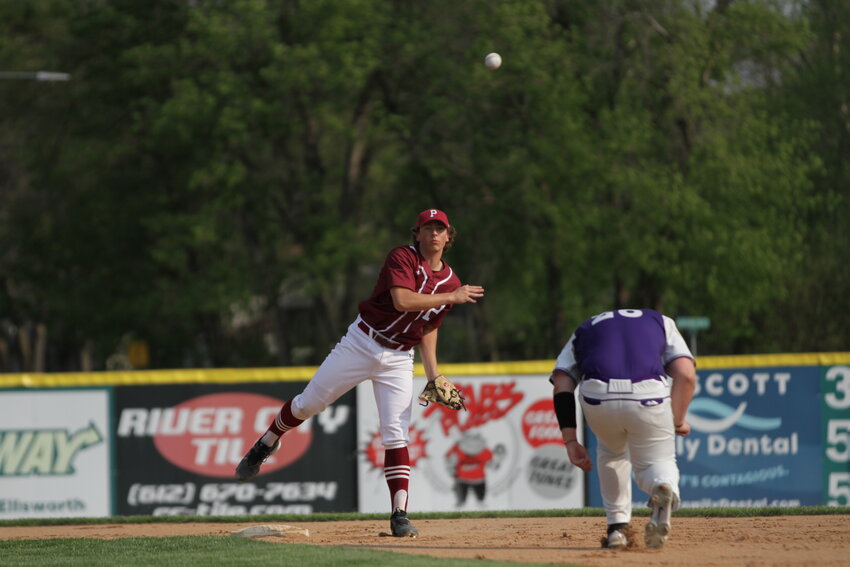 Prescott senior Mason Schommer steps on second base and fires a throw to first to turn a double play during the Cardinals&rsquo; home game against Ellsworth on Tuesday, May 16. Schommer and the Cardinals defeated Ellsworth 11-1 in five innings of action.