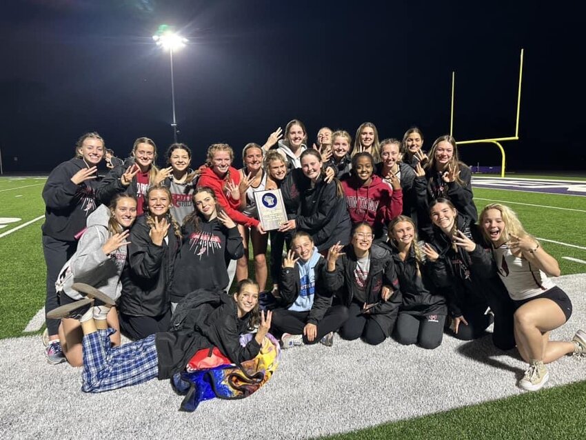 The Prescott High School girls&rsquo; track and field team holds up three fingers signifying their third consecutive Division 2 track and field regional championship. Prescott won the regional title in Durand on Monday, May 22.