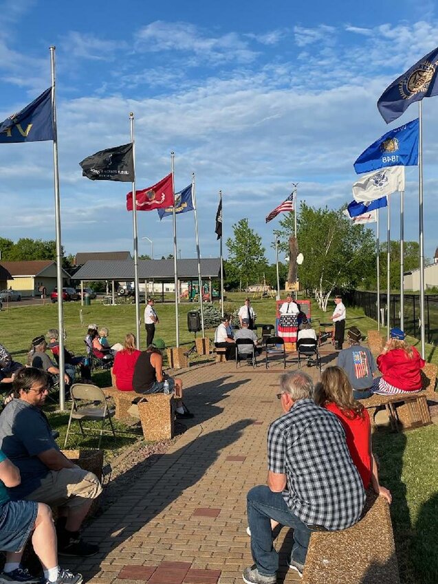 Community members listen respectfully at the Memorial Day Event held at the Stanley Veterans Memorial in Soo Line Park at 7pm on May 29th.