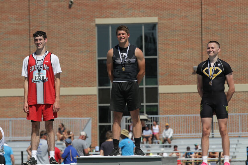 Elmwood/Plum City senior Trevor Asher stands atop the podium wearing his first-place medal after winning the WIAA Division 3 triple jump state championship at Veteran&rsquo;s Memorial Field Complex in La Crosse on Saturday, June 3.