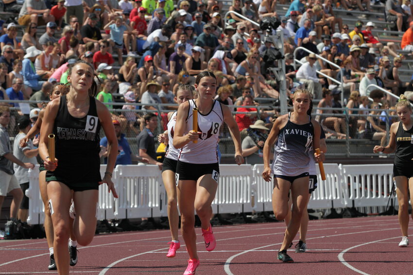 Prescott freshman Amanda Miller takes the baton as she begins her leg of the girls&rsquo; 4x400-meter relay at the Division 2 state championship track and field meet in La Crosse on Saturday, June 3.