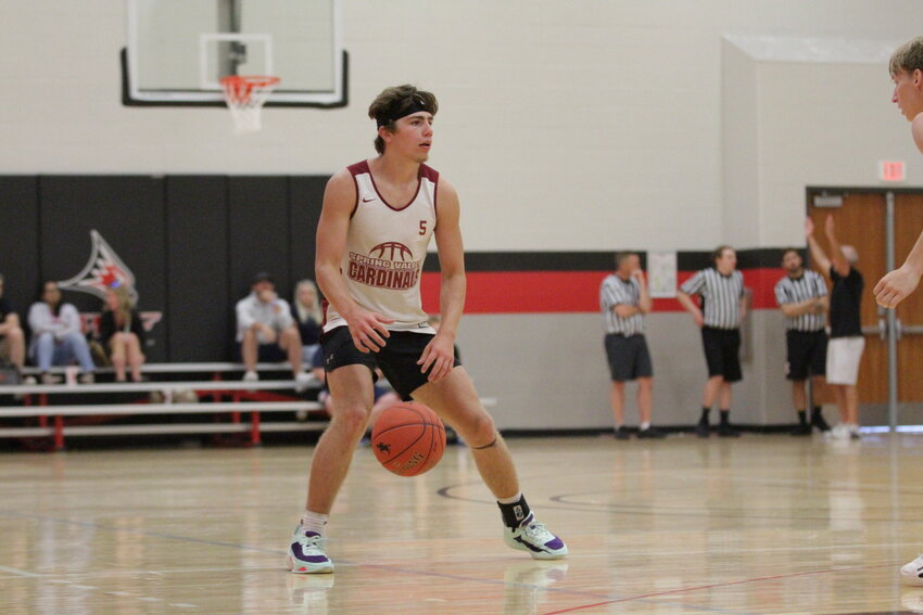 Spring Valley junior Cade Stasiek looks for an open teammate during the Cardinals&rsquo; summer league action at the Falcon Shootout on Saturday afternoon. Stasiek was one of Spring Valley&rsquo;s top players last season and is expected to lead the Cardinals again this winter.