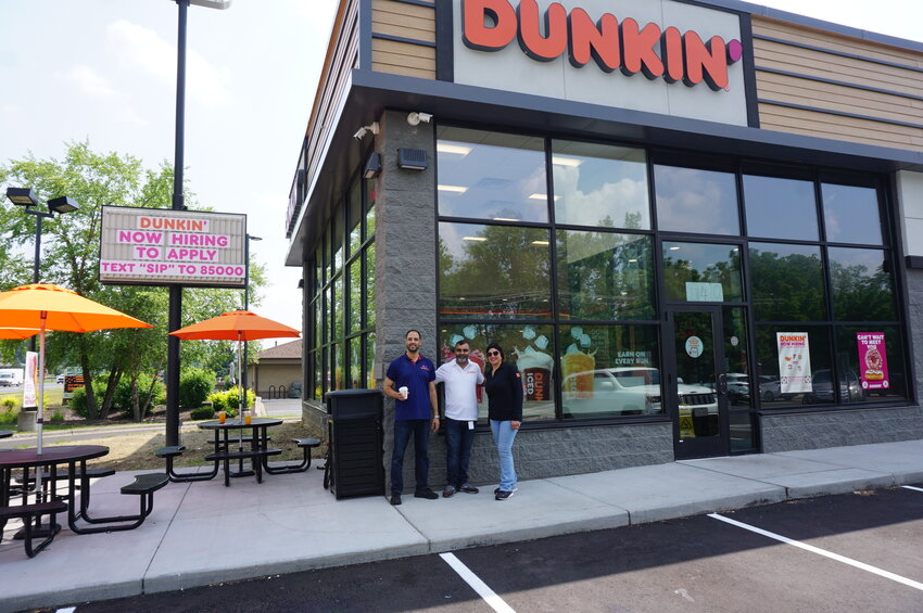 Vice President of Operations Haykel Arfaoui, owner Sahil Taneja and Taneja Companies District Manager Seham A. Wahed standing in front of the newly opened Dunkin&rsquo; Donuts in River Falls.