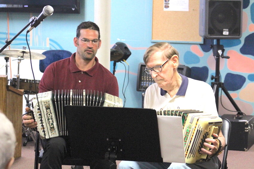 Alex Kulesa (left) looks on with Walter Wartolec as each performs at the concertina event July 9.