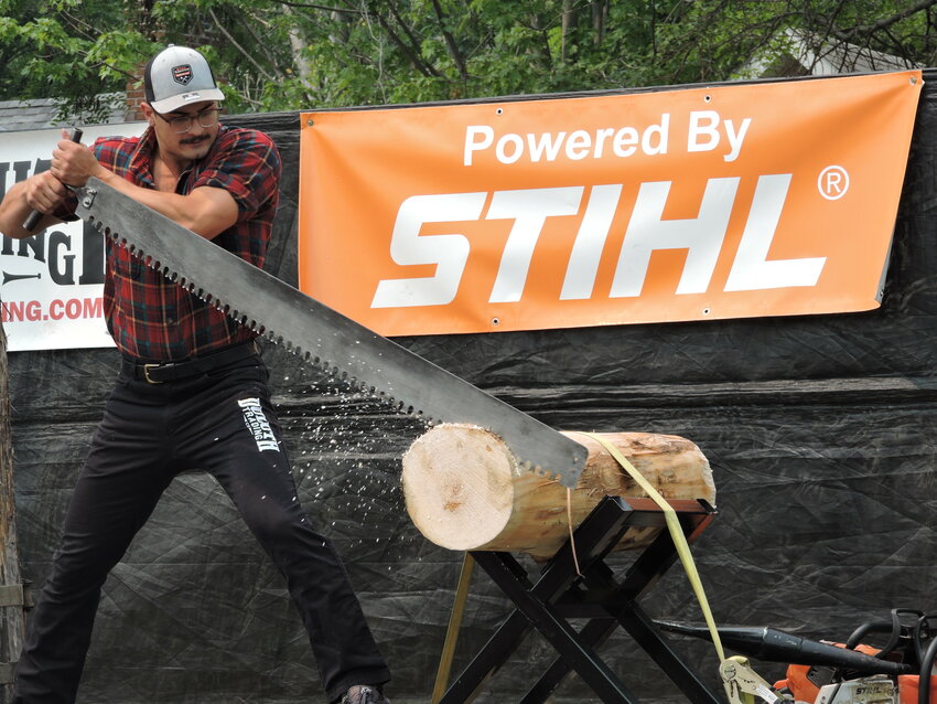 Chet Isaacson, a lumberjack from Wisconsin Dells, competes in the single buck competition at the DLW Timberworks Lumberjack Show Saturday, July 15 during River Falls Days. The single buck saw is razor sharp. Also called a &ldquo;misery whip,&rdquo; lumberjacks use their entire body to move the saw.