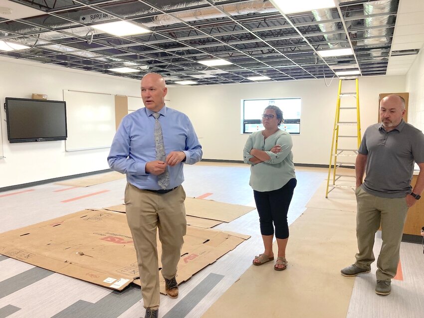 Superintendent Jeff Koenig (left) looks over a classroom in the area of the old middle school lock rooms. With Koenig are board members Becky Peterson (center) and Ryan Lewallen (right).