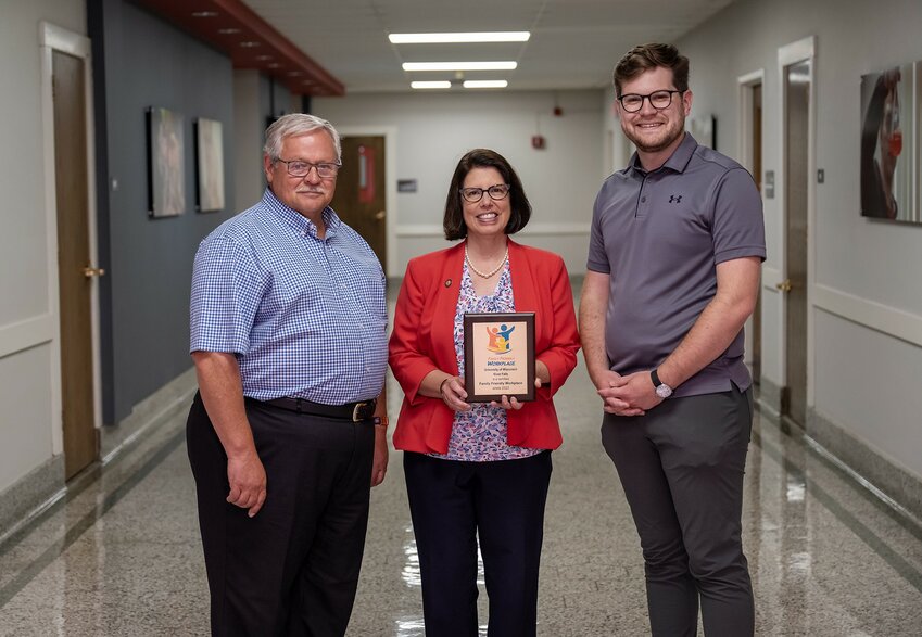 UW-River Falls Chancellor Maria Gallo receives a gold-level Family Friendly Workplace Award Thursday from Mark Tyler, left, founder of Family Friendly Workplaces, and Neil Kline, right, executive director of the organization.