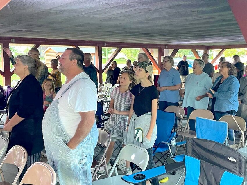 Hands were raised in worship and voices sang in unison at the Revival in the Park at Yellowstone Park in Thorp, Wisconsin.