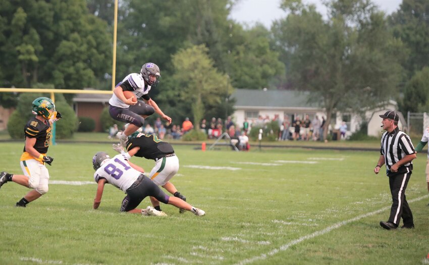 Ellsworth Quarterback Griffin Blomberg leaps over a defender in the Panthers&rsquo; 8-6 victory over Edgar Friday, Aug. 18.