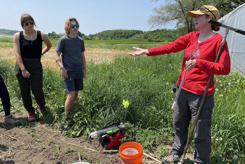Jill Coleman Wasik, associate professor of environmental science who leads the Freshwater Collaborative of Wisconsin effort at UW-River Falls, explains measuring water in the soil to students on May 25 at the university-operated Mann Valley Farm. UW-River Falls is receiving $155,441 in state funding to conduct additional student research on water.