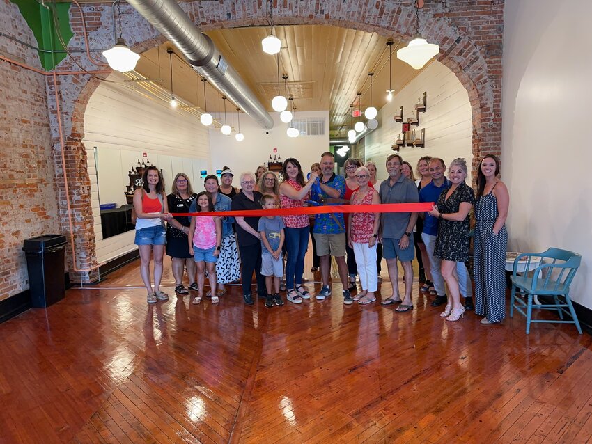 1  Members of the Hastings Area Chamber of Commerce  , the Downtown Business Association and other  distinguished guests joined Wendi and Ryan Johnson in celebrating the ribbon cutting of their new business  called The Studio Downtown.