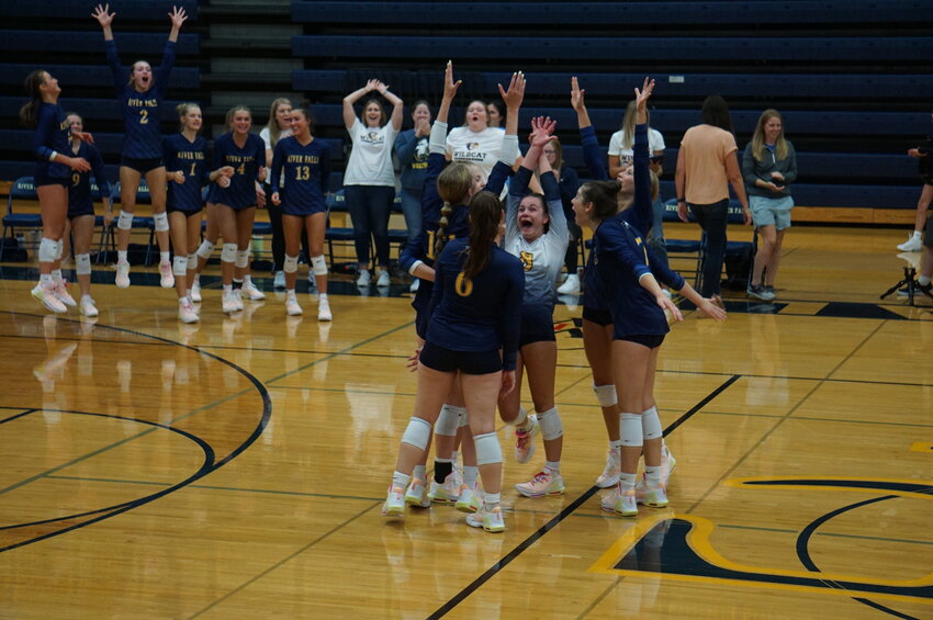 The River Falls Wildcats celebrate after a hard-fought victory against the Chippewa Falls Cardinals in five sets Thursday, after coming back from a two-set deficit.