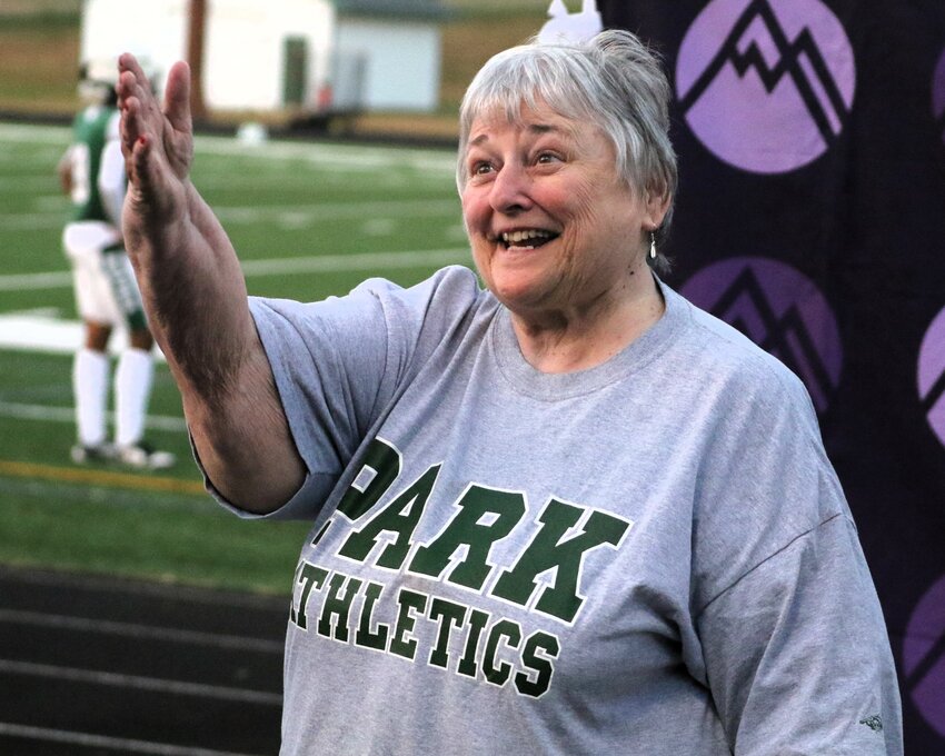 Longtime Park High School teacher and ticket taker Nancy Martinsen waves to the crowd as she is honored during a break in the football game.