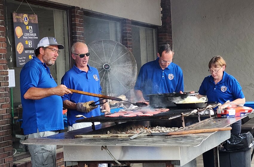 The Spring Valley Lions Club members grill up their &ldquo;world-famous&rdquo; burgers at last year&rsquo;s Dam Days celebration.