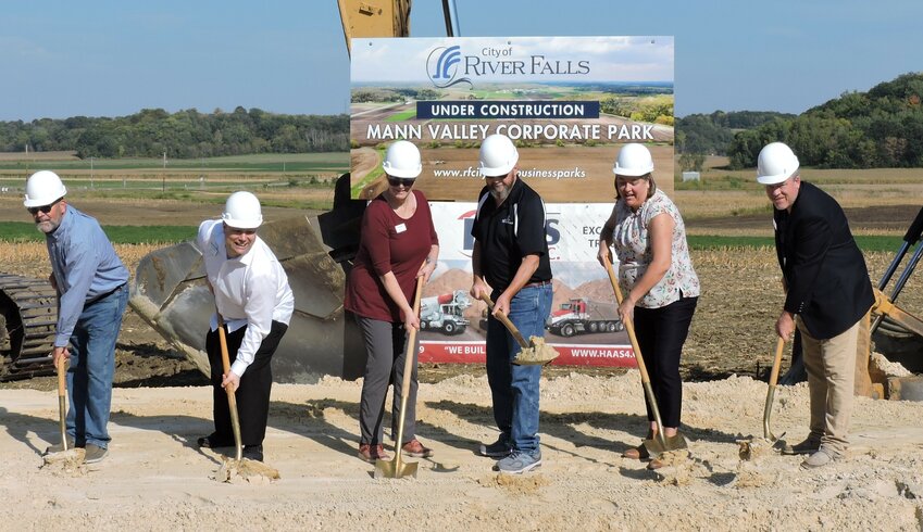 River Falls City Council members (from left) Todd Bjerstedt, Sean Downing, Diane Odeen, Mayor Dan Toland, Alyssa Mueller and Jeff Bjork dig their shovels into the sand Sept. 19 at Mann Valley Corporate Park.