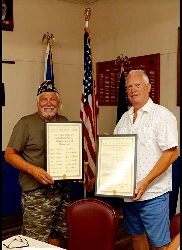 Steve Winberg, Commander of The Sons of the American legion (SAL) presents Jerry Klasen, Commander of the Prescott American Legion Post 61 with the SAL Charter.