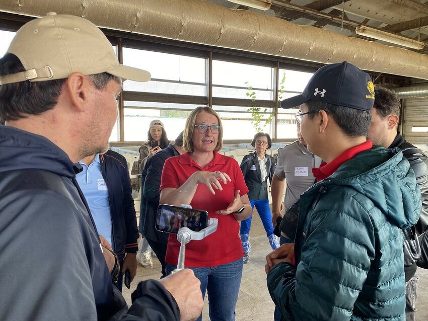 UWRF Dairy Science Professor Sylvia Kehoe, center, speaks with a group of visitors from the central Asian nation of Kazakhstan at Mann Valley Farm Monday. The university hosted the visiting Kazakhstan residents to help them learn how to effectively operate dairy farms.