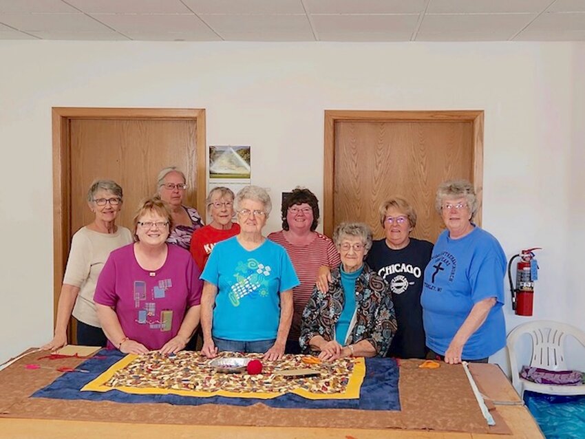 Local Basement Quilters made 500 quilts this year to be sent to Lutheran World Relief. The quilts will be distributed to those in need in 19 countries. Back row from left: Chris Anderson, Sally Carlson, Lora Overgard, Karen Dickson, Charlotte Rollins, and Donna Endru. Front row from left: Jan Berge, Jan Shilts, and Fern LaMarche. Not pictured: Judy Radke, Alden Dahl, Pat Dahl, Jerry Stauber, Sue Thomas, Scott Rollins, and John Dickson.