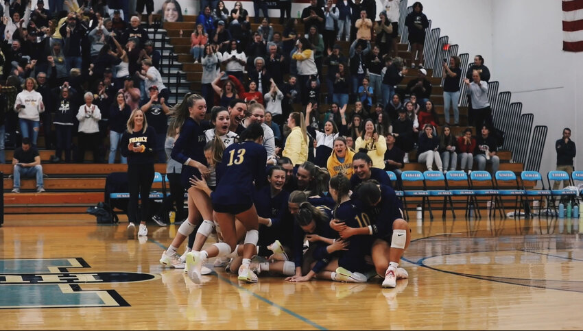 The River Falls volleyball team celebrates the moment together after winning in the sectional round of playoffs against Eau Claire Memorial Saturday, Oct. 28.