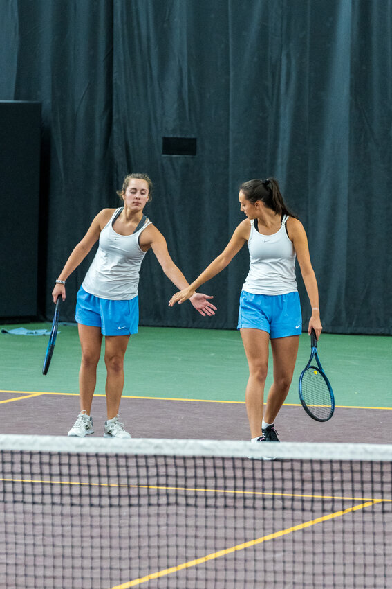 Brooklyn (L) and Reese (R) Keller congratulate each other after winning a point in the Class AA Doubles State tournament. They won the first-round match 4-6, 6-2, 6-1 but fell to the eventual state champions, a duo from Rochester Mayo in round two.
