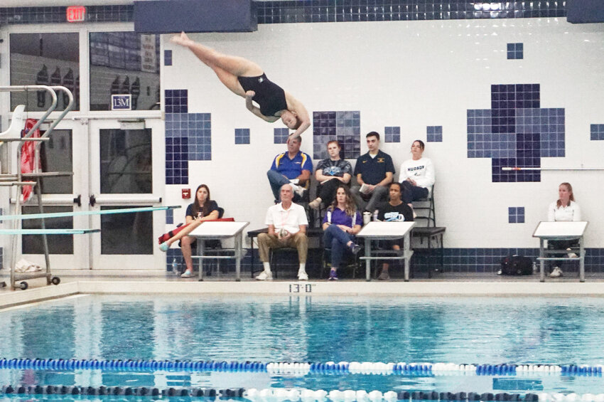 Rachel Everson twisting in midair before completing her top scoring dive of the night at sectionals in Hudson on Friday.