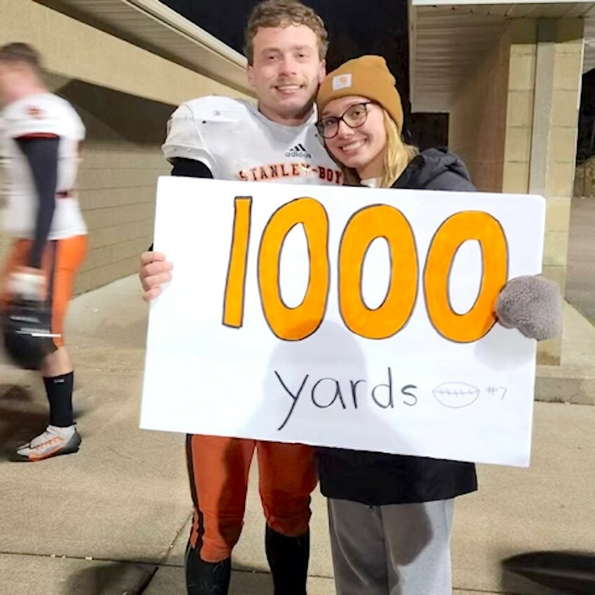 Landon Karlen (left) smiles proudly with Megan Okerglicki as he celebrates having reached his 1,000 yard milestone.