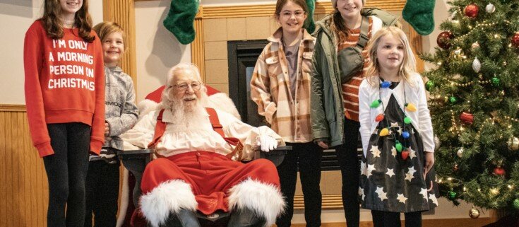 Santa posees with children for a photo at Breakfast with Santa, held at River Oaks.