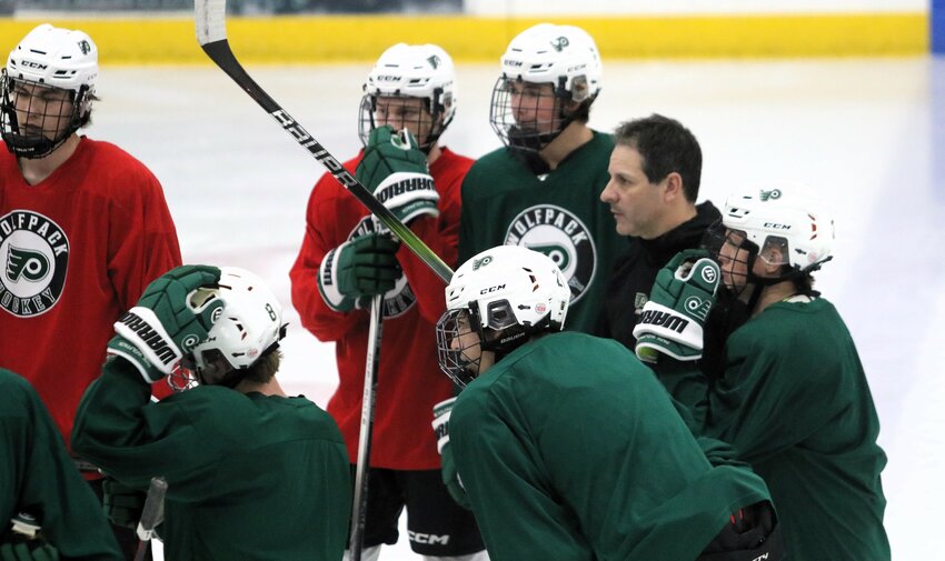 New Park head boys hockey coach Jeff Corkish directs the Wolfpack players during a recent practice.
