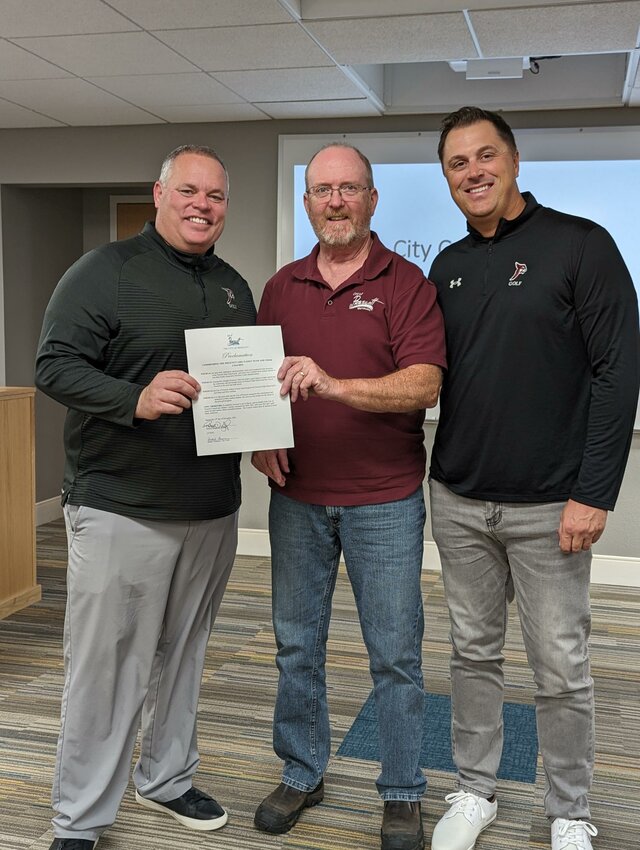 Coaches Chad Salay (right) and Darren Reiter (left) of the Prescott High School Girls&rsquo; Golf Team attended the Prescott City Council&rsquo;s biweekly meeting to accept an official proclamation of commendation from Mayor Robert Daugherty (center) on behalf of the Prescott City Council and City of Prescott citizens.