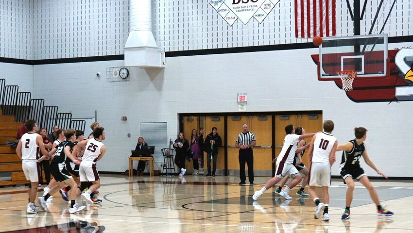 Both teams look on as Cade Stasiek puts up the tying shot at the buzzer in Spring Valley on Thursday night.