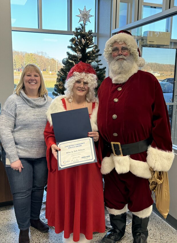 Mike and Deb Wilson received the Live Better Community Service Award from Charity Lubich (left), PPCS vice president of member services and human relations. The award included a certificate of recognition and a $100 MasterCard gift card.