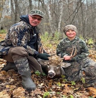 Ellsworth resident Randy Brickner and his 8-year-old grandson Matthew Gaard with the 9-point buck he shot with a crossbow.