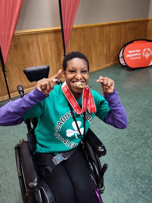 Lidya Sturm proudly shows off the hard-earned gold medal that she received at the Special Olympics State Bowling Tournament in Weston, Wisconsin.