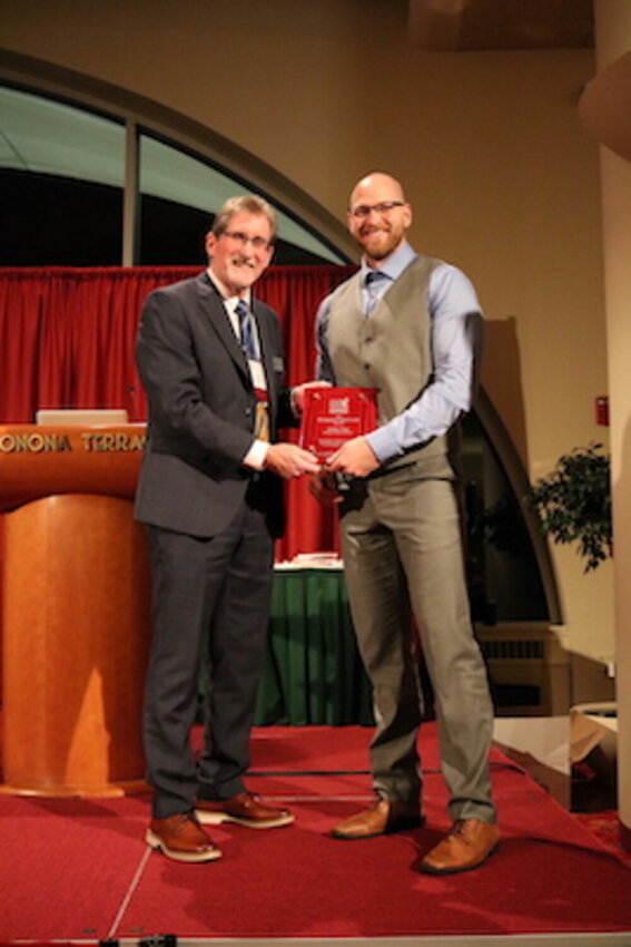 WMEA President Brad Schneider presents Prescott High School Principal Josh Fiege with the WMEA Distinguished Administrator Award at the annual Wisconsin State Music Conference on Oct. 25 in Madison.