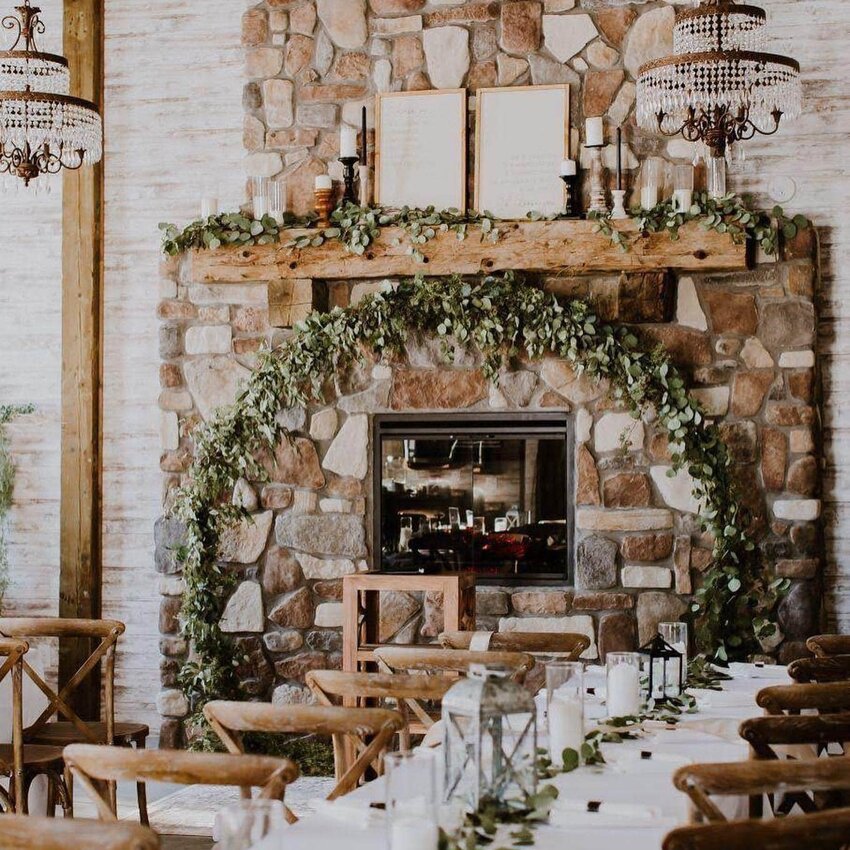 The wedding venue at Forevermore Forest Weddings &amp; Events is reminiscent of a rustic, woodsy lodge. The fireplace makes a perfect centerpiece.