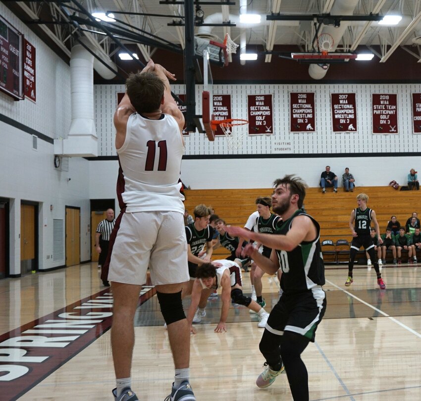 Kaden Robelia shoots for three in a home game against Eau Claire Immanuel.