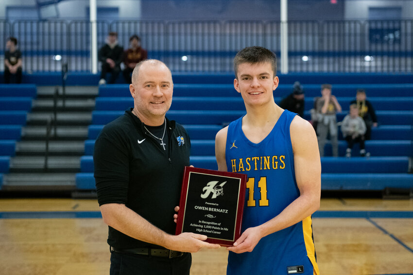 Hastings Raiders boys basketball coach Chad Feikema presented a plaque to senior guard Owen Bernatz, commemorating his 1000th point in his Raider career at the onset of Friday night&rsquo;s home game against Two Rivers. Bernatz hit the milestone Jan. 12 at South St. Paul.