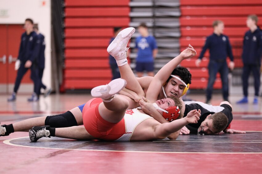 Cristobal Estrada worked to pin a Two Rivers opponent in a recent meet.