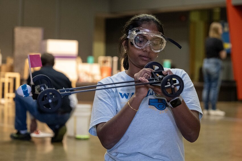 Avantika Sivakumar, a senior at Wayzata, Minn., High School, meticulously winds the wheels of a car as part of her team&rsquo;s participation in the &ldquo;Scrambler&rdquo; event Saturday during the Science Olympiad competition at UW-River Falls. Sivakumar was among 900 high school students who participated in the competition that focuses on many aspects of science.